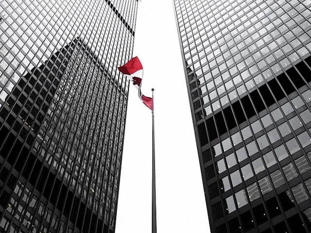 Toronto's Financial District, with the Canadian flag between office towers